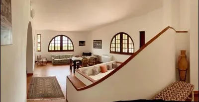 a living room with a staircase leading to a living room at Villa San Vito Bay in Macari