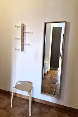 a mirror on a wall with a chair and a mirror at Villa delle Pomelie - Castellammare del Golfo in Alcamo