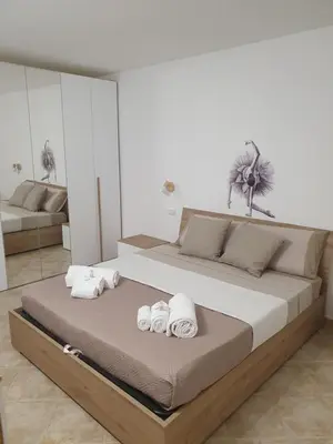 a bedroom with a large bed with towels on it at Dancing Apartment in Castelluzzo