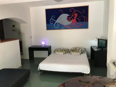 a room with two beds and a painting on the wall at park house mini in Mondello