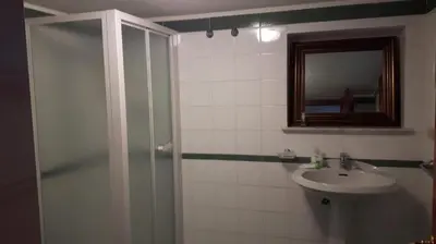 a bathroom with a shower and a sink and a mirror at park house mini in Mondello