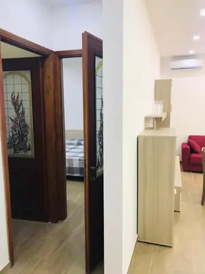 a living room with a door and a red couch at Casa Vacanze da Peppe in Palermo