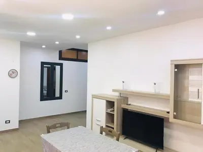 a living room with a table and a fireplace at Casa Vacanze da Peppe in Palermo