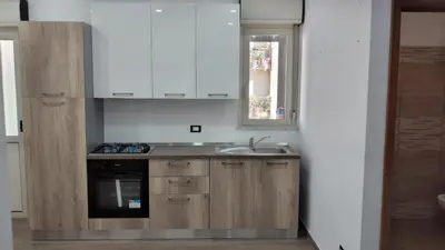 a kitchen with white cabinets and a sink at Casa Vacanze da Peppe in Palermo