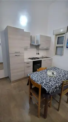 a kitchen with a table and a kitchen with a stove at Casa Vacanze da Peppe in Palermo