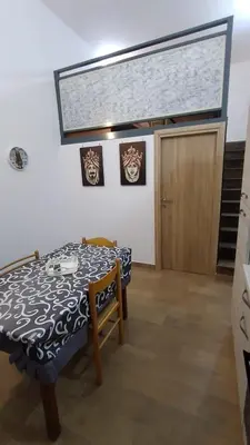 a dining room with a table and a door at Casa Vacanze da Peppe in Palermo