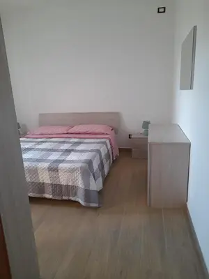 a bedroom with a bed and a wooden floor at Casa Vacanze da Peppe in Palermo