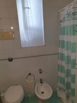 a bathroom with a toilet and a sink at Casa Delizia in Lido di Mondello