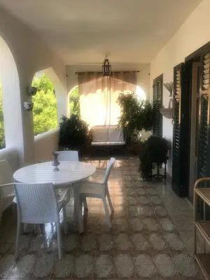 a living room with a table and chairs and a couch at Casa Delizia in Lido di Mondello