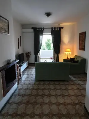 a living room with a green couch and a fireplace at Casa Delizia in Lido di Mondello