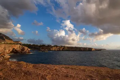 a view of the ocean from a rocky shoreline at Le Yucche in Partinico