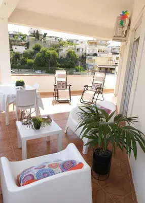 a white table and chairs on a balcony at Limoncello Apri la finestra e respira il profumo del mare Alloggio Spazioso in Sicilia Comfort per 6 Ospiti in Castellammare del Golfo