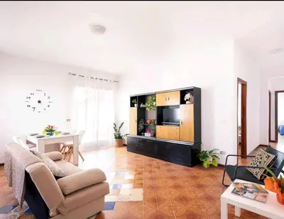 a living room with a couch and a tv at Limoncello Apri la finestra e respira il profumo del mare Alloggio Spazioso in Sicilia Comfort per 6 Ospiti in Castellammare del Golfo
