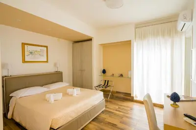 a bedroom with a bed and a table and a desk at Le Stanze dei Tesori - Luxury Rooms in Palermo