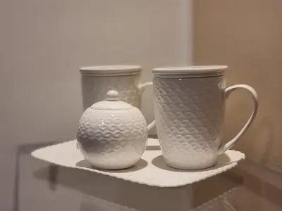 two vases and two cups on a shelf at Le Stanze dei Tesori - Luxury Rooms in Palermo
