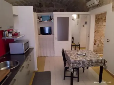 a bedroom with two beds and a window at Casamaqueda26, Bilocale indipendente presso palazzo Filangeri-Cutò in Palermo