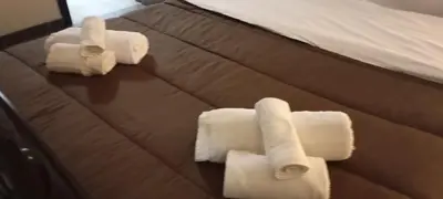 three rolls of white towels on a bed at Maya Palace Real Rooms Palermo centre close to Cathedral in Palermo