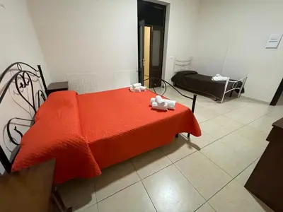 a bedroom with a bed with a red blanket at Maya Palace Real Rooms Palermo centre close to Cathedral in Palermo