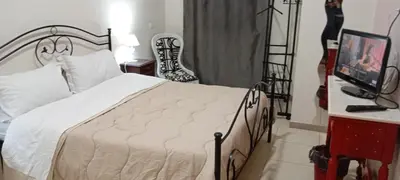a bedroom with a bed and a television and a chair at Maya Palace Real Rooms Palermo centre close to Cathedral in Palermo