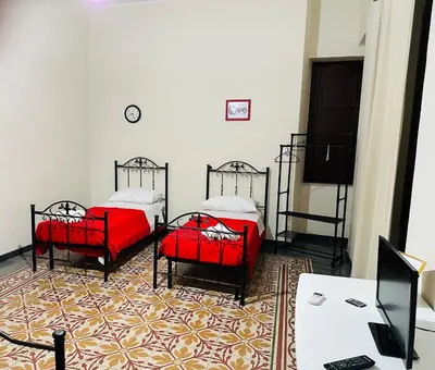 a room with two beds and a desk with a computer at Maya Palace Real Rooms Palermo centre close to Cathedral in Palermo