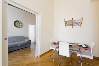 a living room with a table and a couch at Quattro canti luxury apartment in Palermo