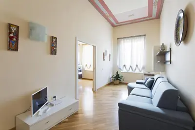a living room with a blue couch and a tv at Quattro canti luxury apartment in Palermo
