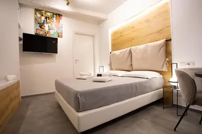 a bedroom with a bed and a tub and a television at LUXURY SUITE SANT ISIDORO in Palermo