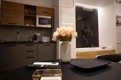 a vase of flowers on a table in a kitchen at LUXURY SUITE SANT ISIDORO in Palermo