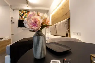 a vase filled with flowers sitting on a table at LUXURY SUITE SANT ISIDORO in Palermo