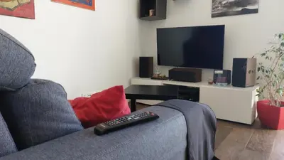 a remote control sitting on a couch in front of a television at La terrazza sul Castello in Palermo