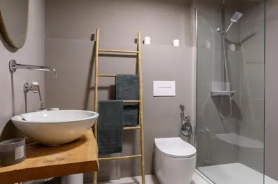 a bathroom with a sink and a toilet and a shower at Suite Gharraf Palermo Old Town in Palermo