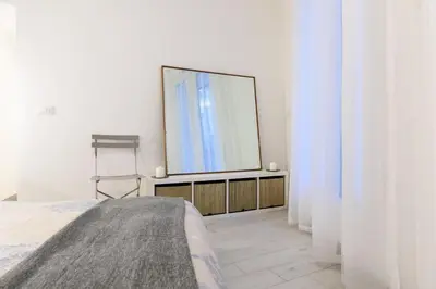 a bedroom with a large mirror and a bed at Suite Gharraf Palermo Old Town in Palermo