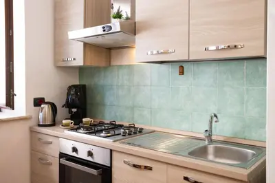 a kitchen with a sink and a stove at Hola House al Capo in Palermo