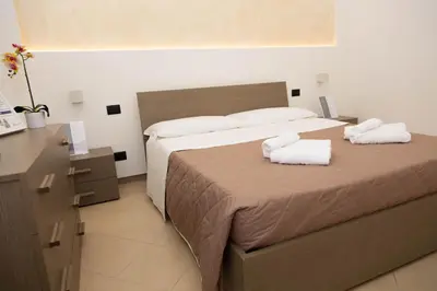 a bedroom with a bed with two towels on it at Piave77 in Bagheria