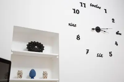 a shelf with a clock on a white wall at Piave77 in Bagheria