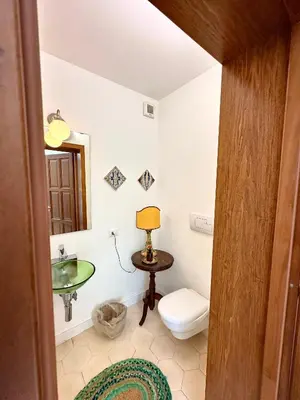 a bathroom with a toilet and a sink at Stunning Seafront Villa in Scopello Pool & Jacuzzi in Scopello