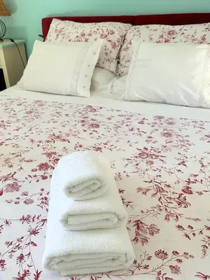 a bed with white towels on top of it at Stunning Seafront Villa in Scopello Pool & Jacuzzi in Scopello