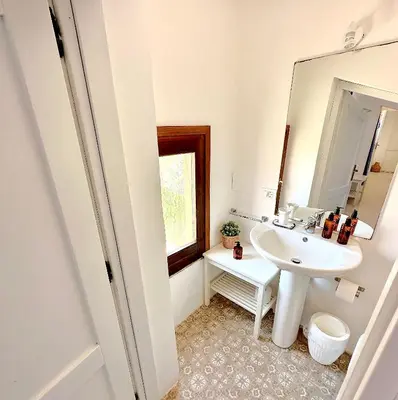 a bathroom with a sink and a mirror at Stunning Seafront Villa in Scopello Pool & Jacuzzi in Scopello