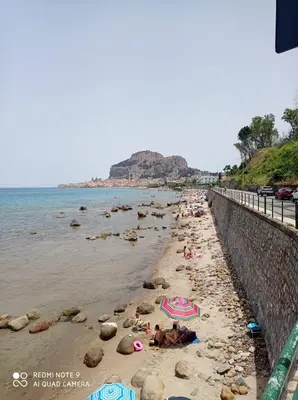 a group of people laying on a beach at Holiday Homes in Campofelice di Roccella