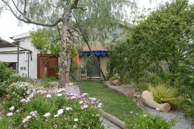 a garden with flowers in front of a house at Holiday Homes in Campofelice di Roccella