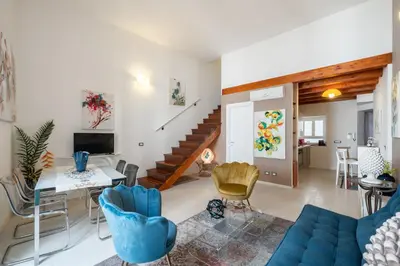 a living room with a blue couch and chairs at Suite San Sebastiano by DomuSicily in Palermo