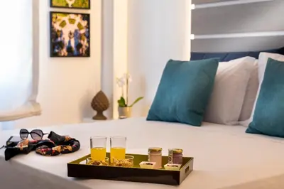 a tray of drinks and glasses on a bed at La Musa Apartments & Rooms in Palermo
