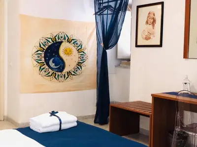 a room with a bed and a painting on the wall at B&B Al Piazza Marina in Palermo