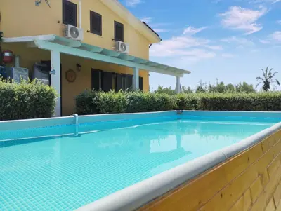 a swimming pool in front of a house at Garden Voyages Balestrate in Balestrate