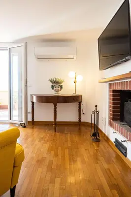 a living room with a piano and a fireplace at Politeama rooftop in Palermo