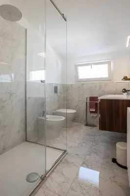 a bathroom with a shower and a toilet and a sink at Politeama rooftop in Palermo