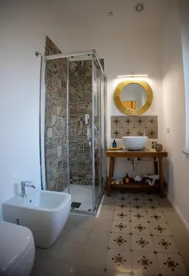 a bathroom with a tub and a sink and a shower at Petrarca Suite in Palermo