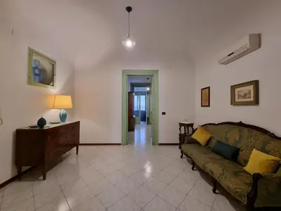 a living room with a couch and a table at Piazza Politeama in Palermo