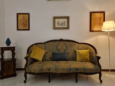 a couch with yellow pillows in a living room at Piazza Politeama in Palermo