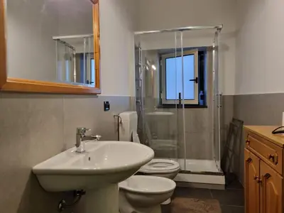 a bathroom with a sink and a toilet and a shower at Piazza Politeama in Palermo